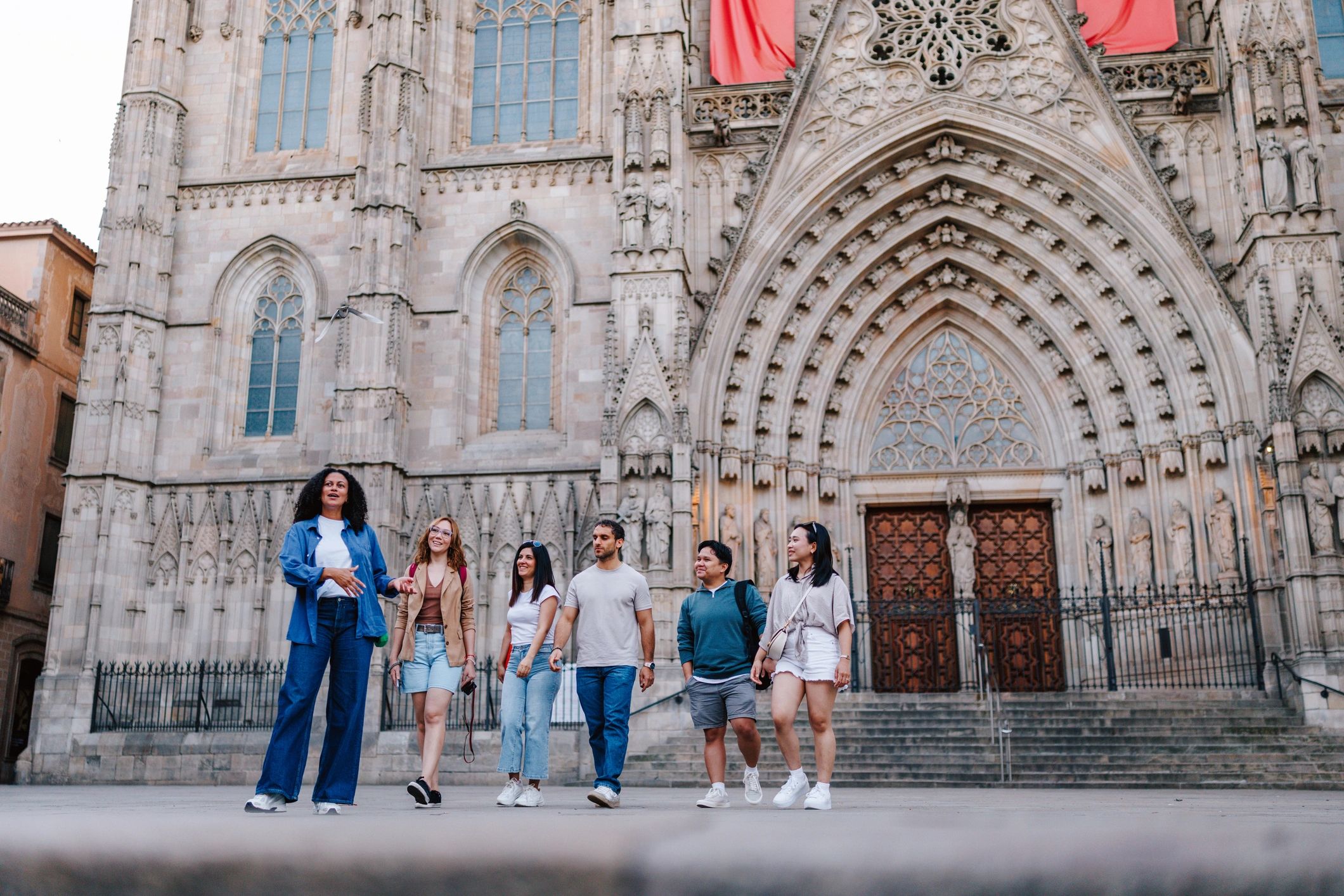 Travelers exploring Barcelona Cathedral with a local guide